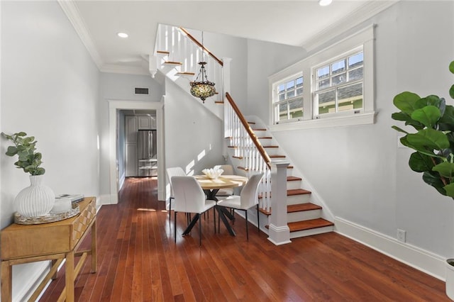 dining space featuring ornamental molding and dark wood-type flooring