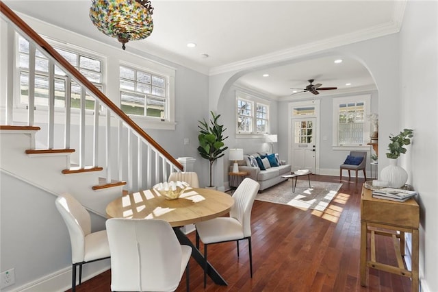 dining space featuring crown molding, dark wood-type flooring, and ceiling fan