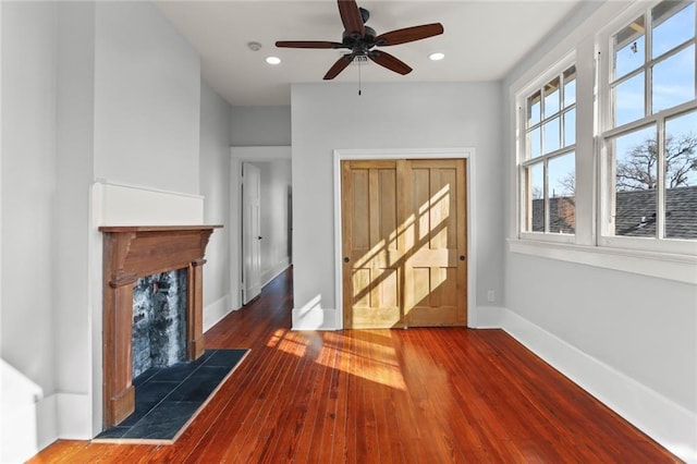 entrance foyer with hardwood / wood-style flooring and a tile fireplace