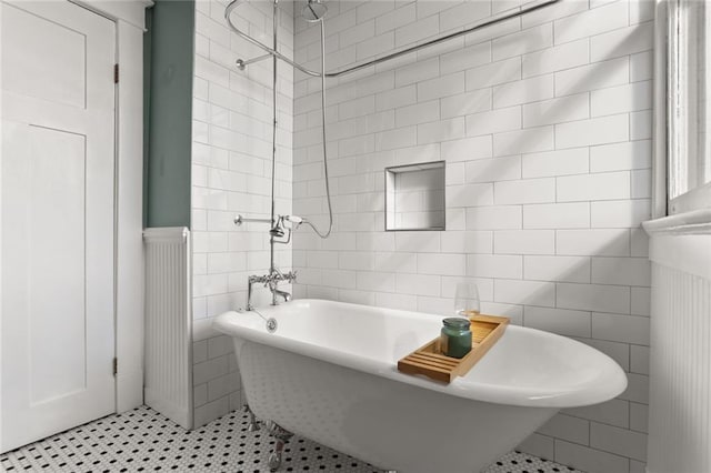 bathroom featuring shower / washtub combination, tile patterned flooring, and tile walls