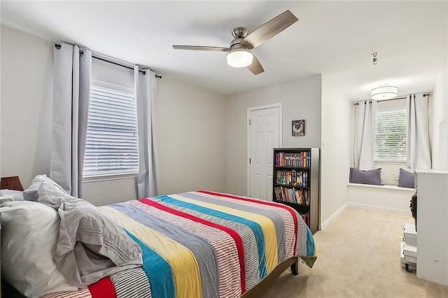 carpeted bedroom featuring ceiling fan