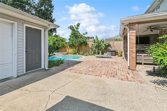 view of patio with a fenced in pool and ceiling fan