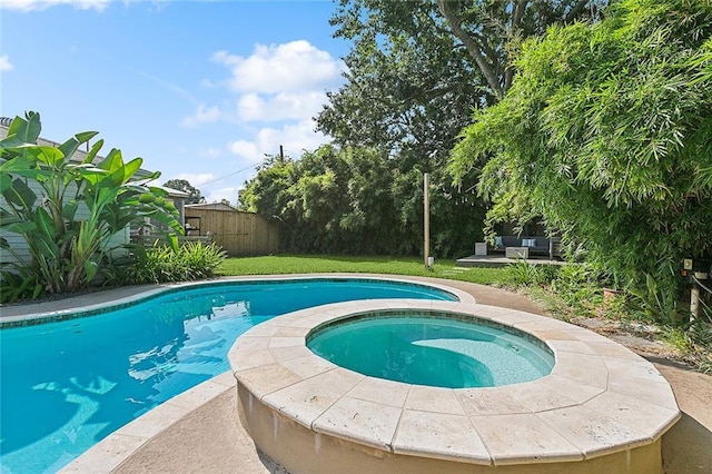 view of pool featuring an in ground hot tub