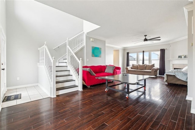 living room with hardwood / wood-style floors, ornamental molding, and ceiling fan