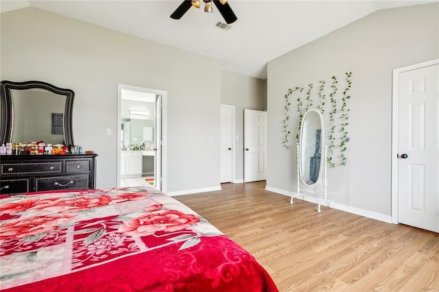 bedroom featuring lofted ceiling, connected bathroom, wood-type flooring, and ceiling fan