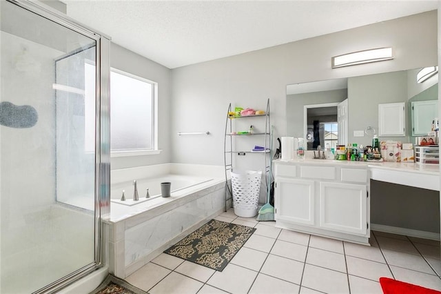 bathroom with tile patterned floors, vanity, and independent shower and bath