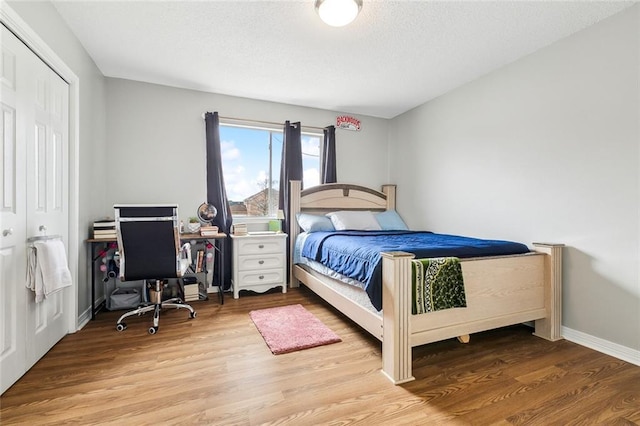 bedroom featuring hardwood / wood-style floors and a closet