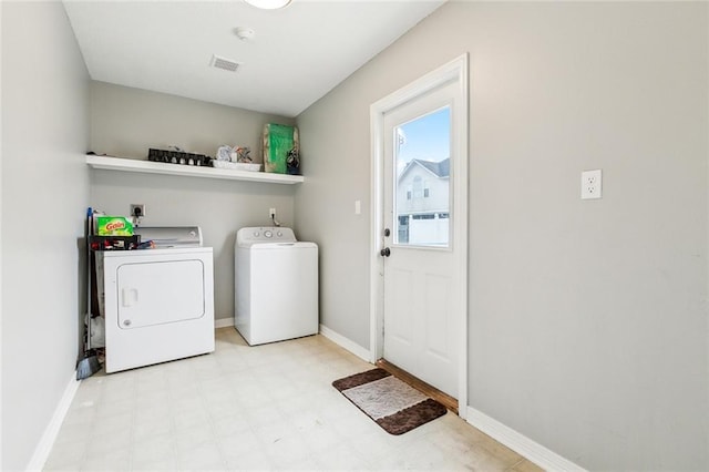 clothes washing area featuring independent washer and dryer