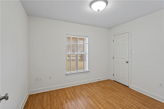 unfurnished room with light wood-type flooring