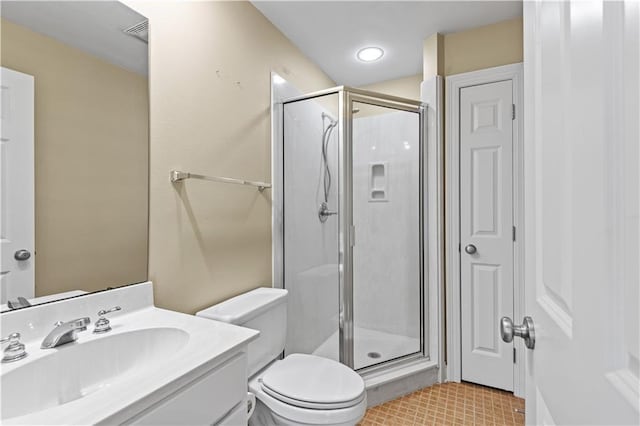 bathroom featuring tile patterned flooring, vanity, an enclosed shower, and toilet