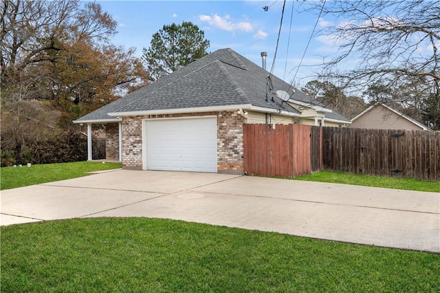 view of side of home with a garage and a lawn