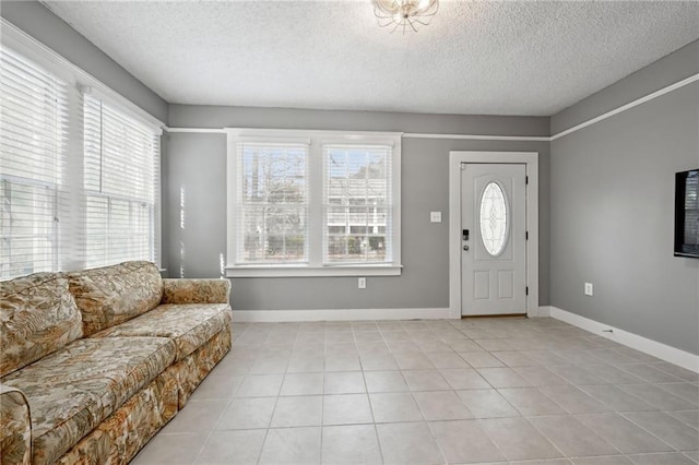 tiled foyer entrance with a textured ceiling