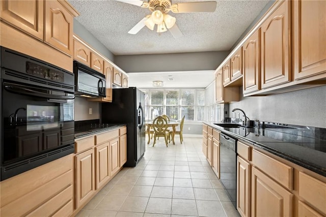 kitchen featuring sink, black appliances, a textured ceiling, and light tile patterned flooring