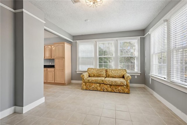 living area featuring light tile patterned floors and a textured ceiling