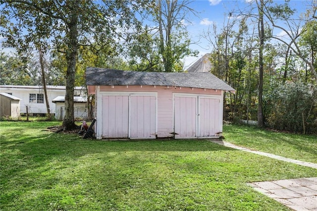 view of outbuilding featuring a yard