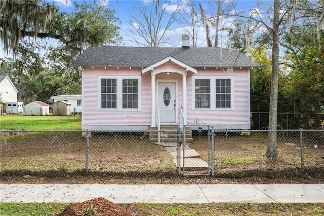 bungalow-style home with a front yard