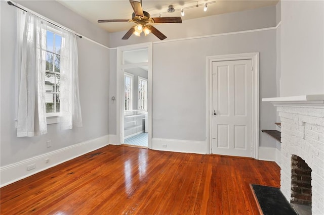 unfurnished living room with wood-type flooring and ceiling fan