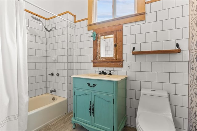 full bathroom with shower / bathtub combination with curtain, tile walls, vanity, wood-type flooring, and toilet