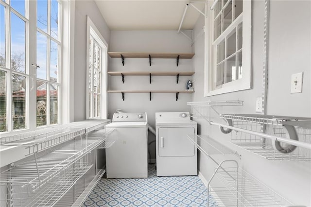 clothes washing area featuring separate washer and dryer