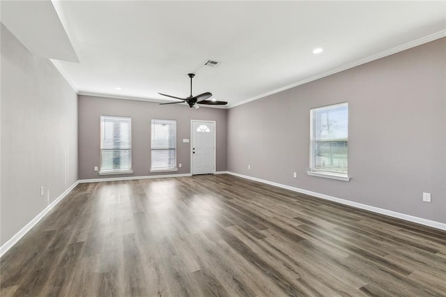 unfurnished living room featuring crown molding, a healthy amount of sunlight, ceiling fan, and dark hardwood / wood-style floors