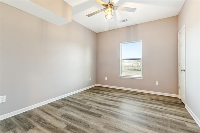 empty room with hardwood / wood-style floors and ceiling fan