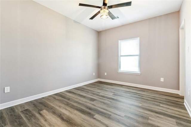 spare room featuring dark wood-type flooring and ceiling fan