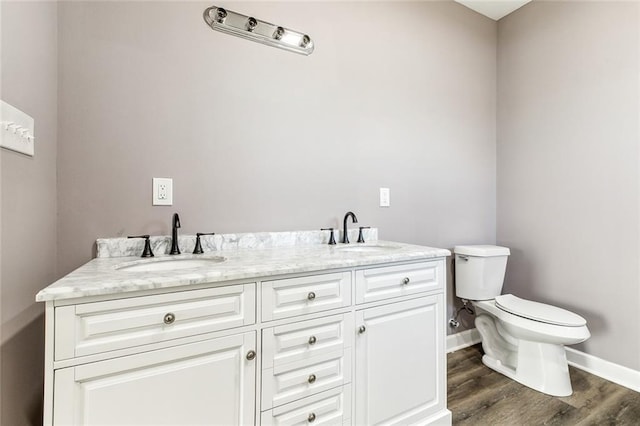 bathroom featuring vanity, hardwood / wood-style floors, and toilet