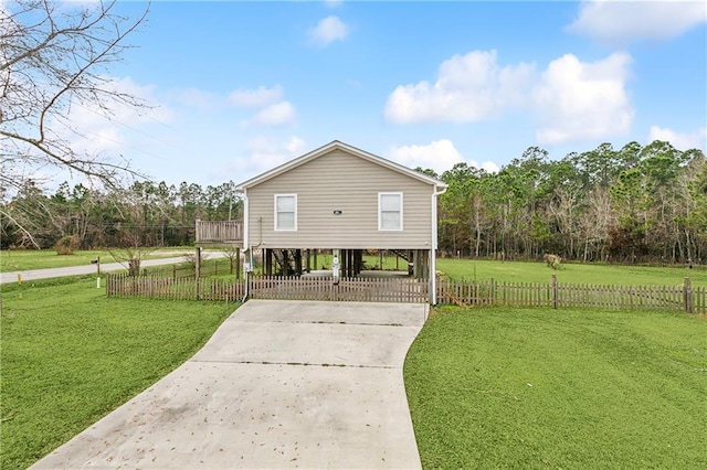 view of side of property with a carport and a lawn