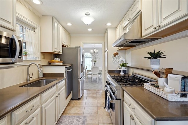 kitchen with white cabinetry, stainless steel appliances, sink, and light tile patterned floors