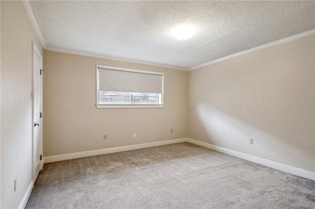 carpeted empty room with ornamental molding and a textured ceiling