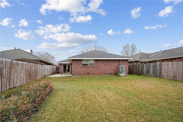 rear view of house with a yard and a patio area