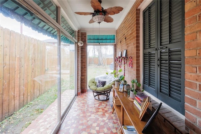 sunroom / solarium featuring ceiling fan