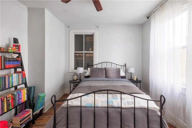 bedroom featuring hardwood / wood-style flooring and ceiling fan