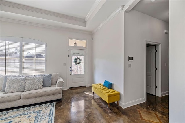 entryway with ornamental molding, plenty of natural light, and a tray ceiling