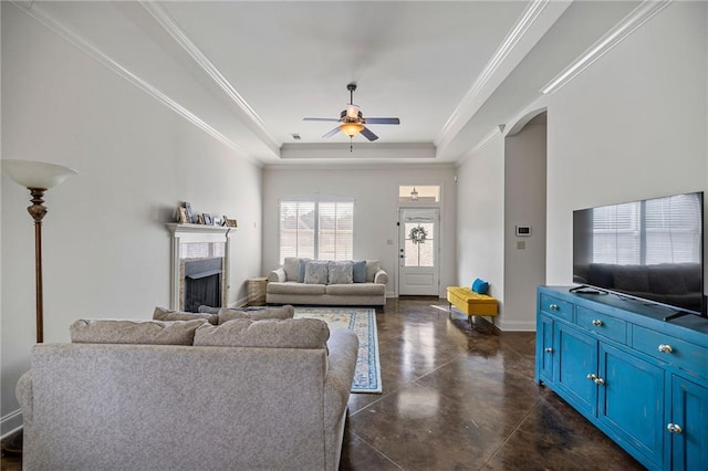 living room featuring crown molding, a raised ceiling, and ceiling fan