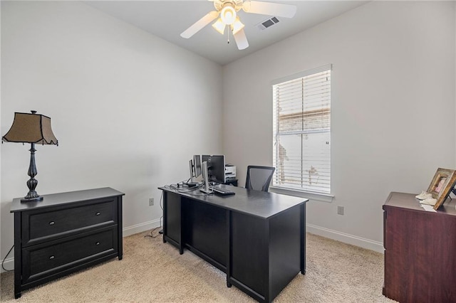 carpeted office featuring ceiling fan