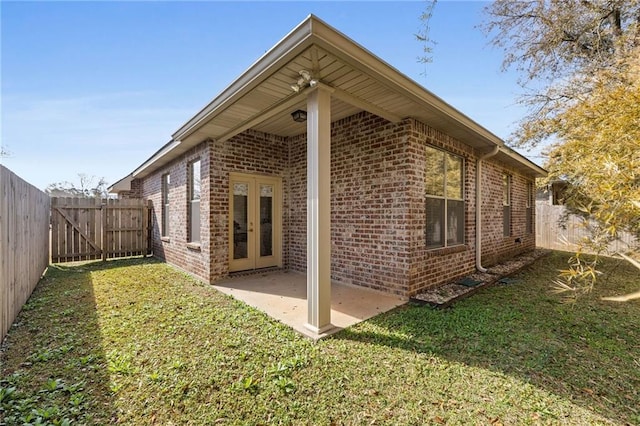 view of property exterior featuring french doors, a yard, and a patio area