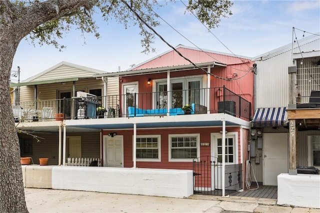 rear view of property featuring a balcony