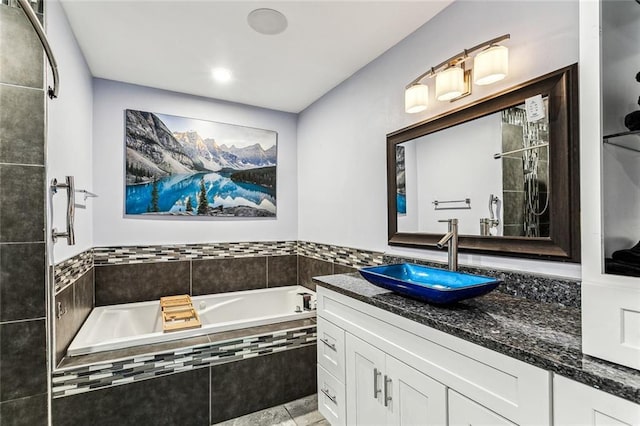 bathroom with a relaxing tiled tub and vanity