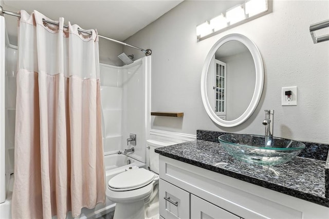 full bathroom featuring shower / tub combo, vanity, and toilet