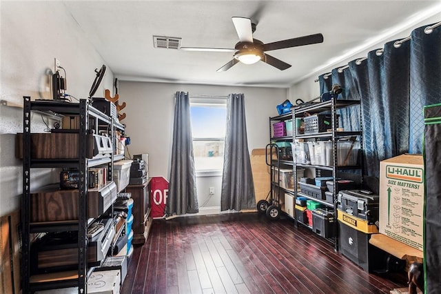 misc room with dark wood-type flooring and ceiling fan