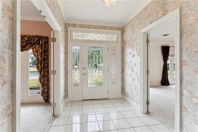 foyer featuring light tile patterned floors and ornamental molding