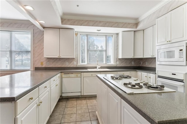 kitchen with ornamental molding, light tile patterned floors, white cabinets, and white appliances