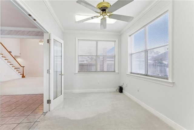 carpeted empty room with crown molding and ceiling fan