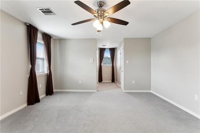 carpeted empty room featuring ceiling fan