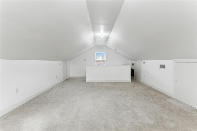 bonus room featuring lofted ceiling and light carpet