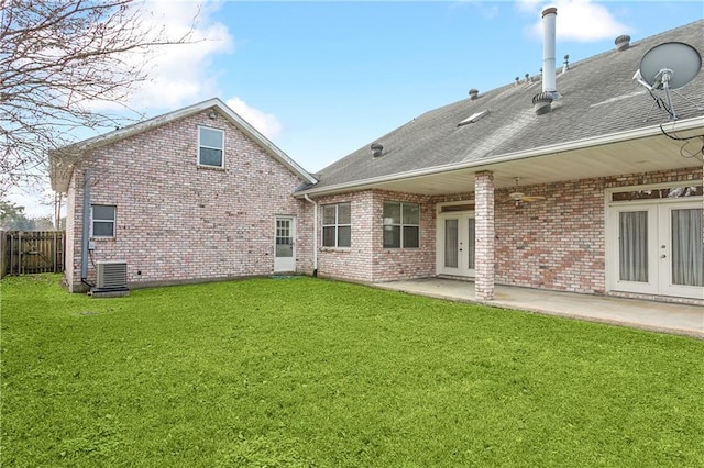 back of property with a patio, central AC, and a lawn