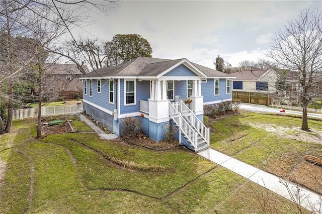 bungalow-style home with covered porch and a front lawn