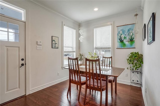 dining area featuring ornamental molding, plenty of natural light, and dark hardwood / wood-style flooring