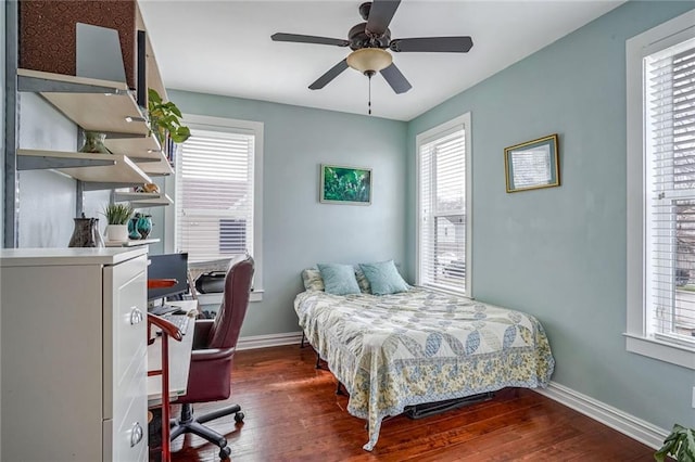 bedroom with ceiling fan and dark hardwood / wood-style floors